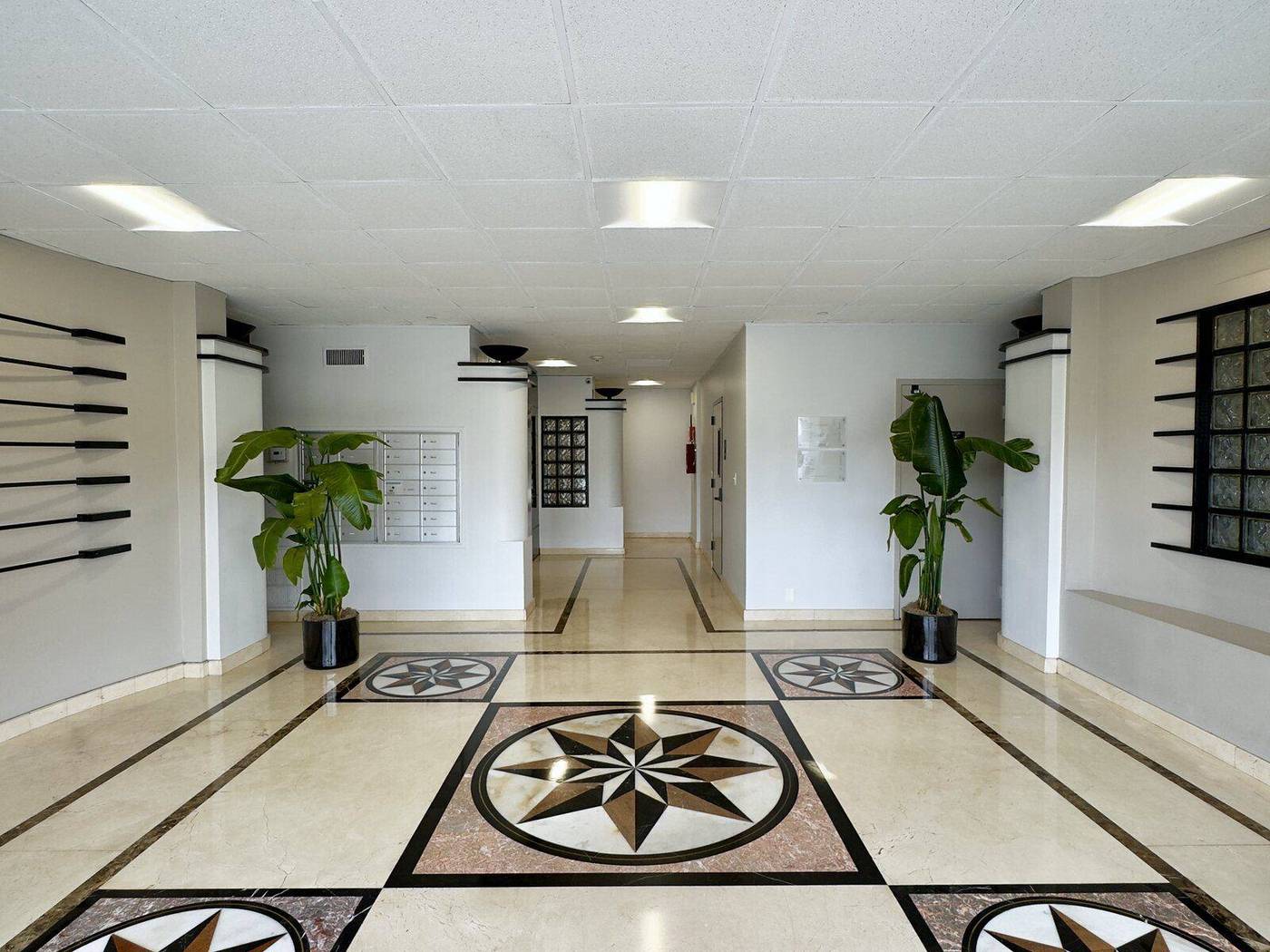 The marble lobby of the building at 5440 Morehouse Dr, home of Sorrento Valley Chiropractic